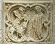 Panel 22:04 - Bearded man killing a lion with a sword, watched by a hooded man with a walking stick
